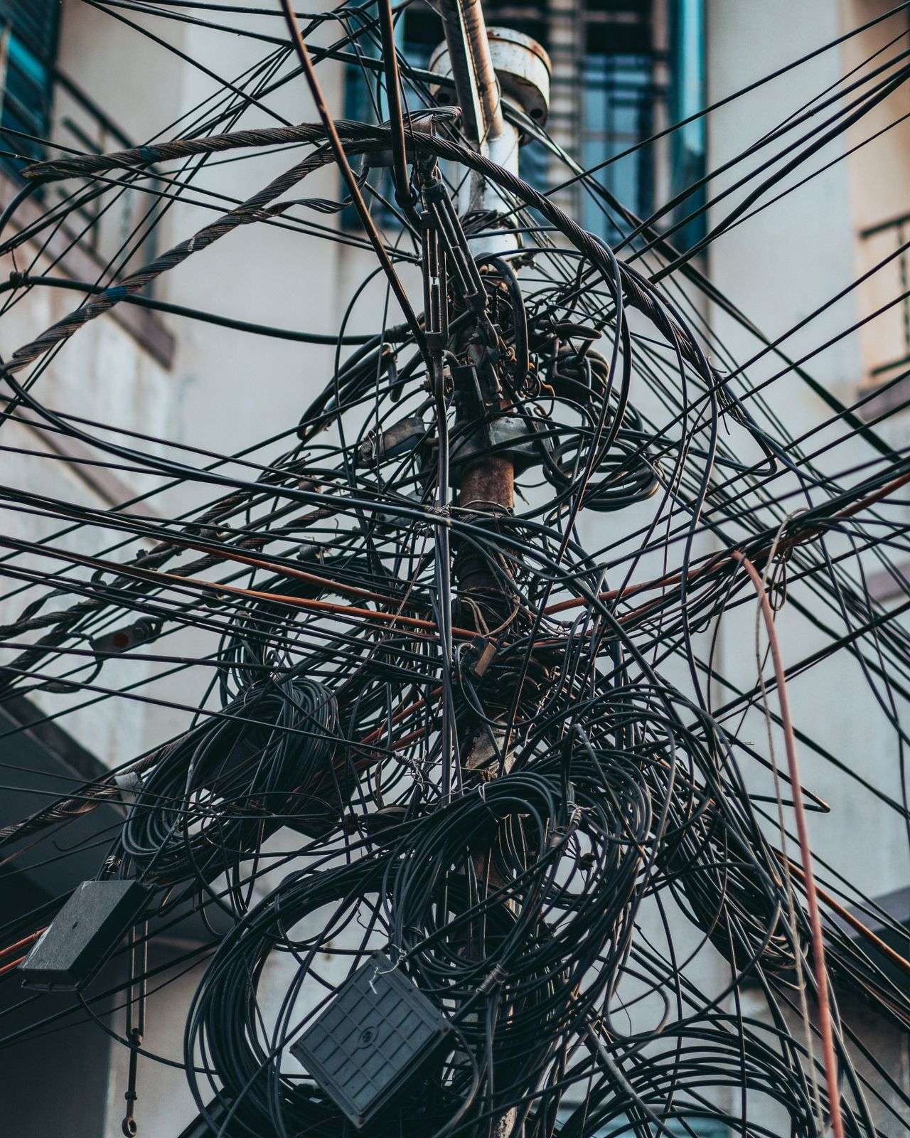 Electric utility wires and power lines on a pole above a city street