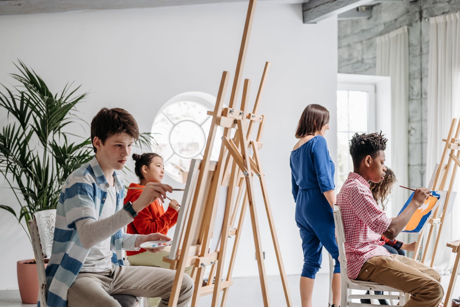 Students working on artwork during a classroom art session