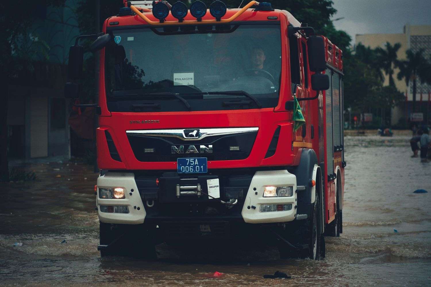 A truck partially submerged in bay waters during a rescue