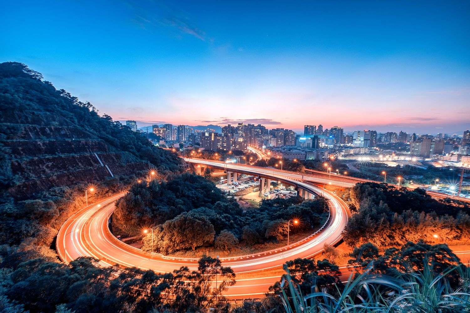 Long-exposure view of an urban highway overpass at dusk