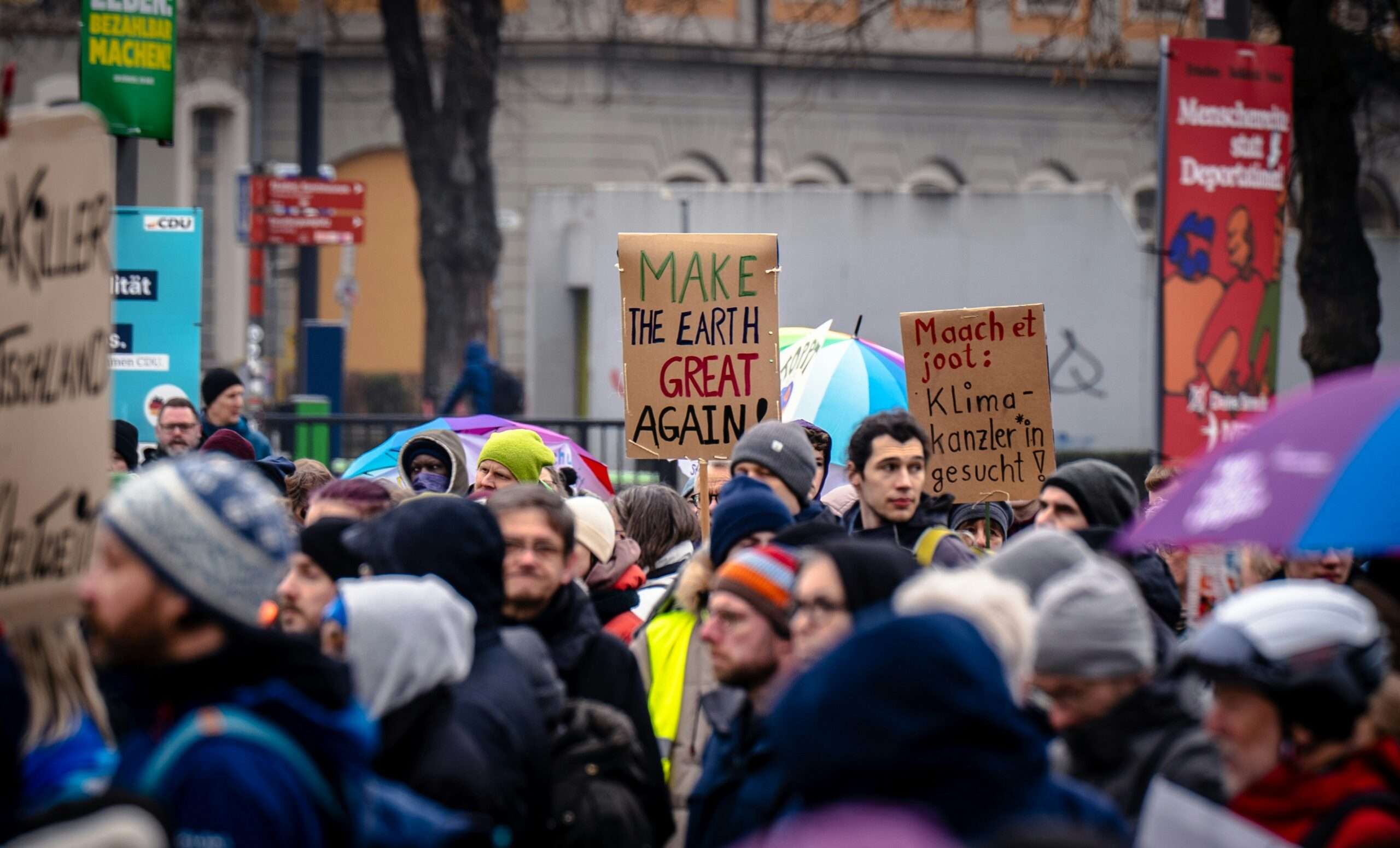 Protesters carrying signs while marching down a downtown street