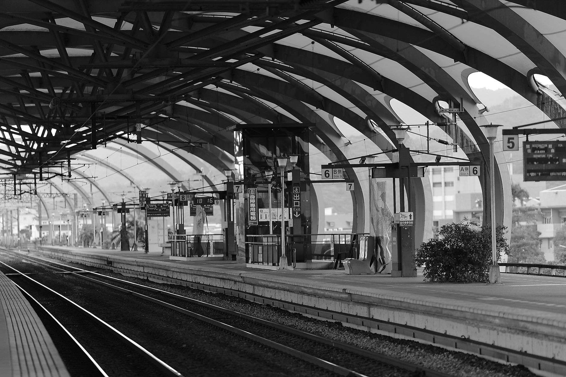 An empty passenger rail platform at a downtown train terminal.