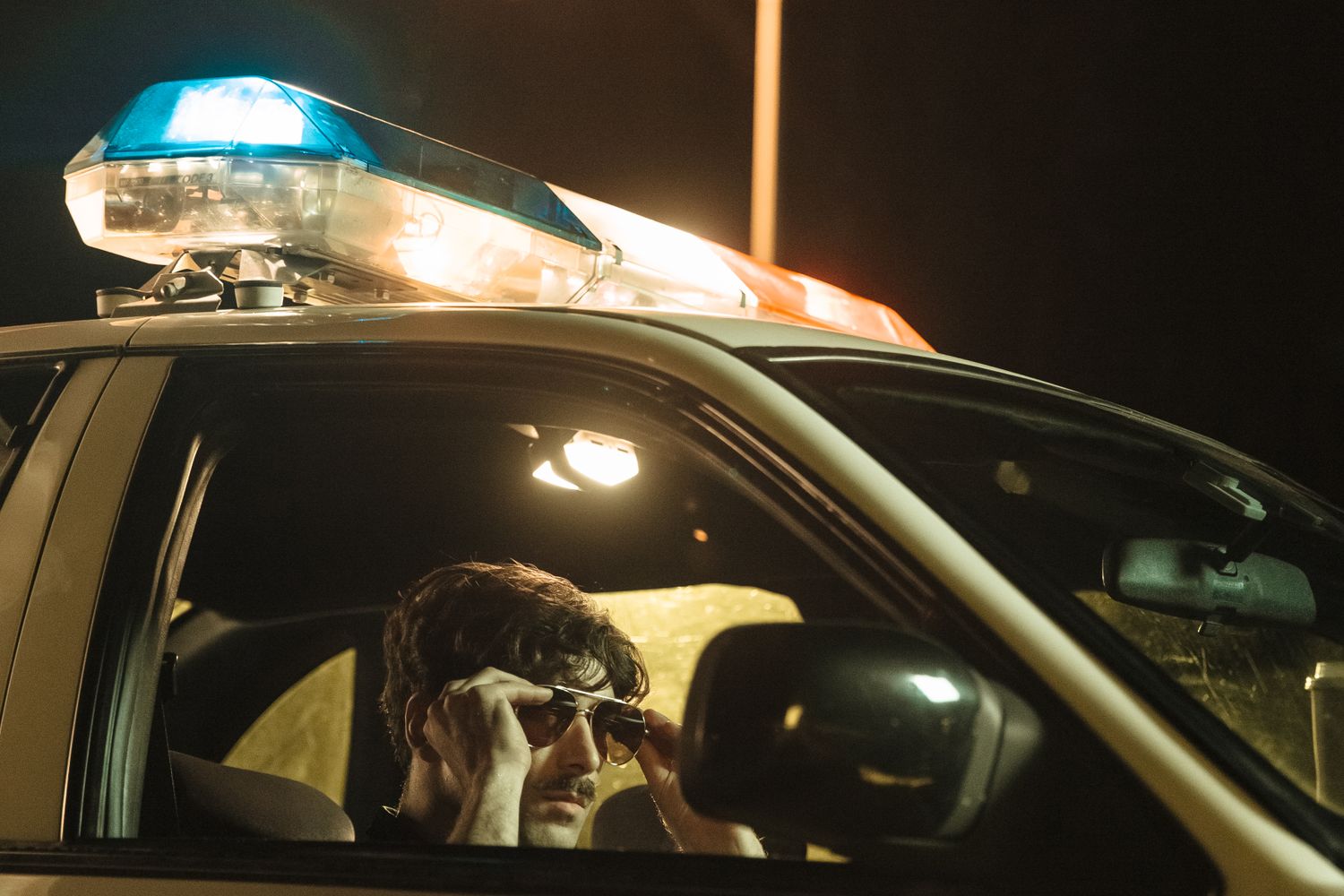 Police cruiser with flashing lights on a Mobile street