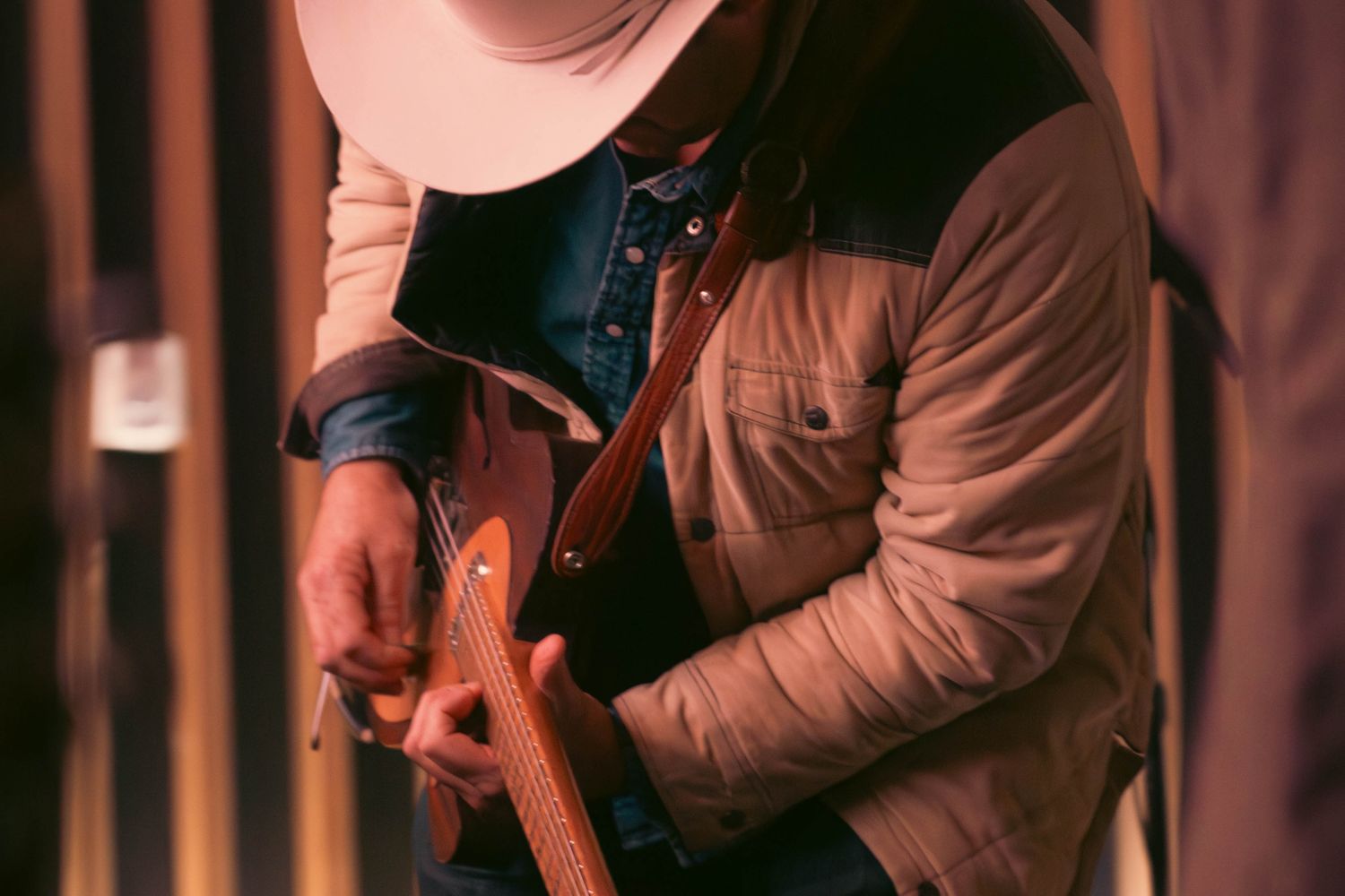 Country singer-songwriter playing acoustic guitar during a live set