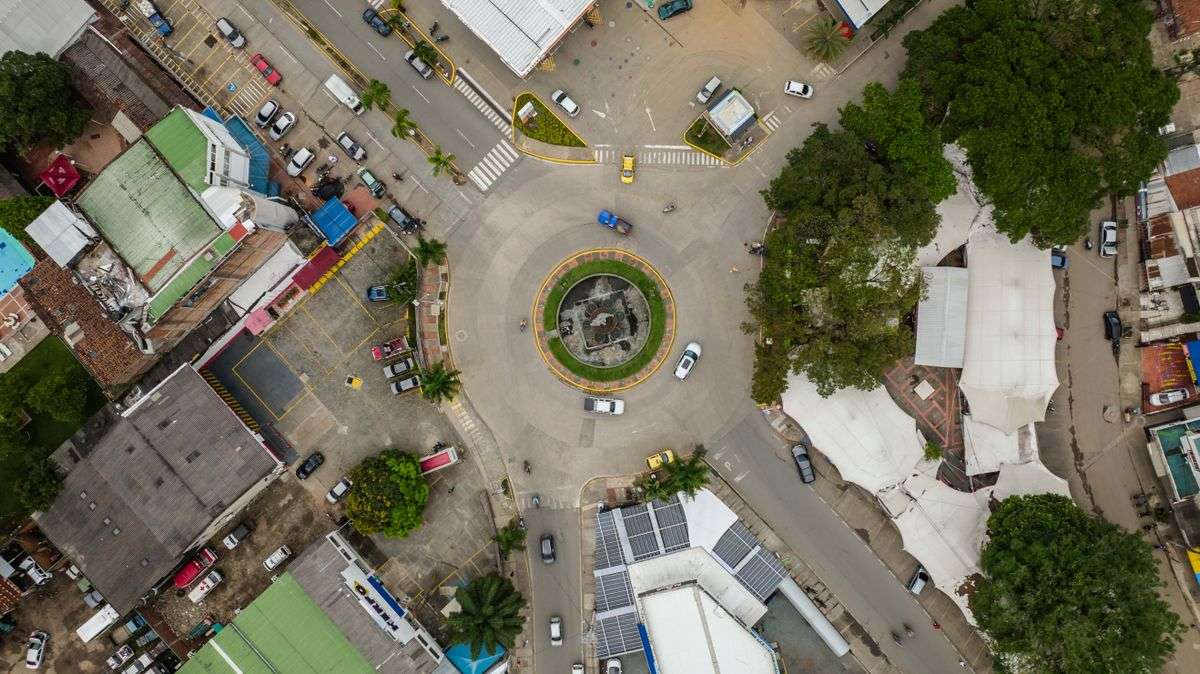 Aerial view of vehicles moving through a roundabout intersection