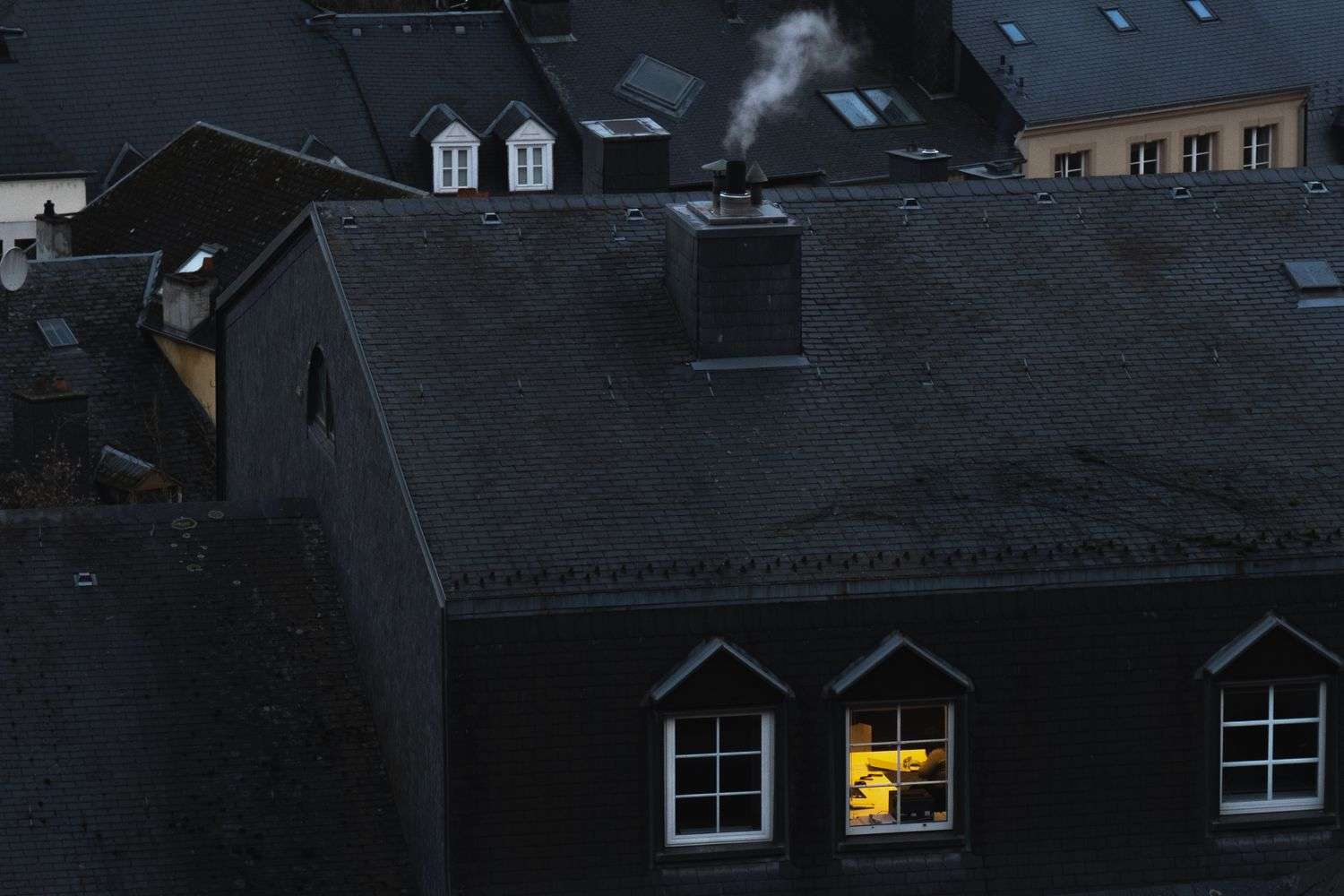 Smoke coming from a house as firefighters respond