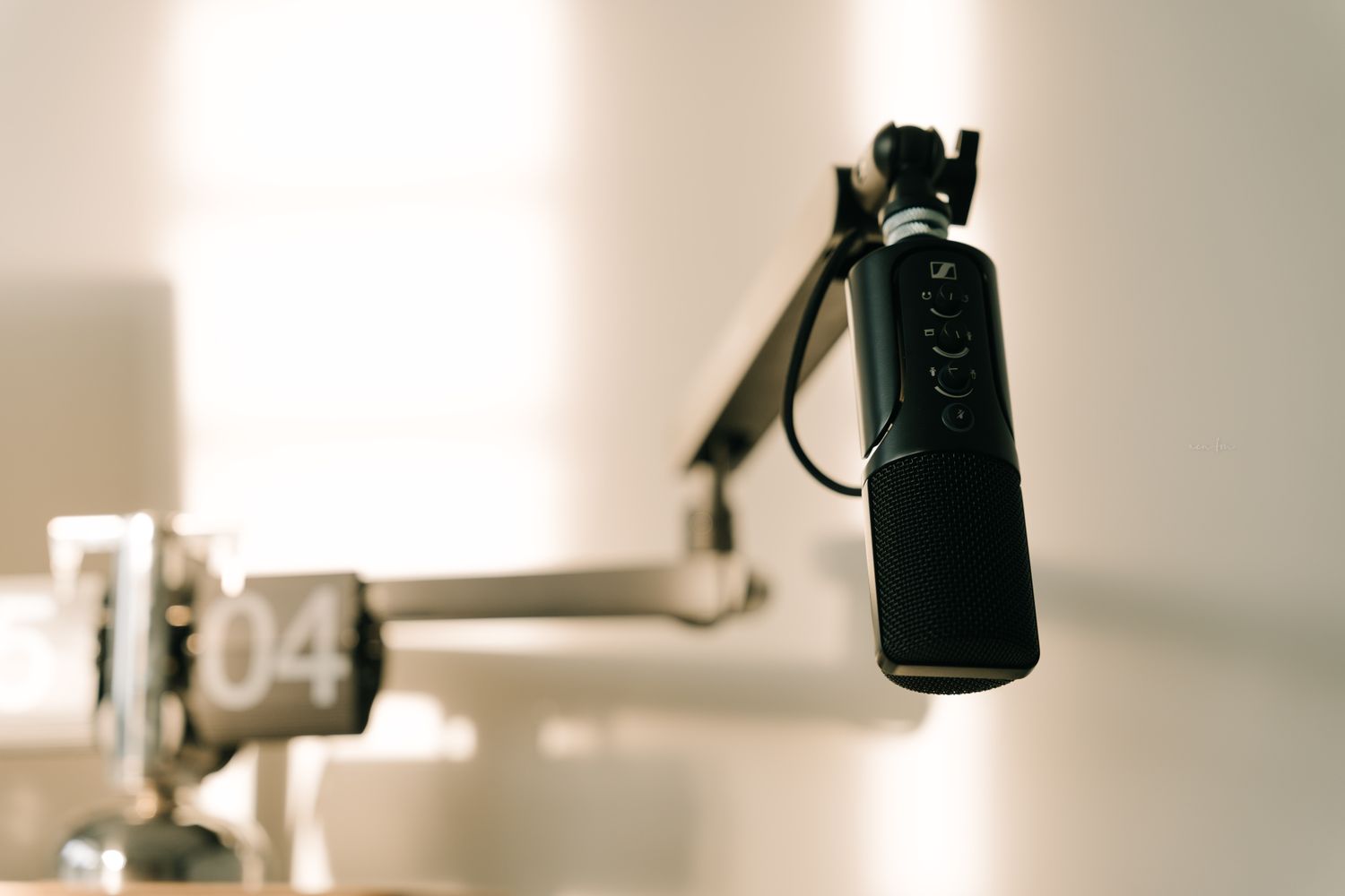 A broadcast microphone in a radio studio set up for a live candidate debate