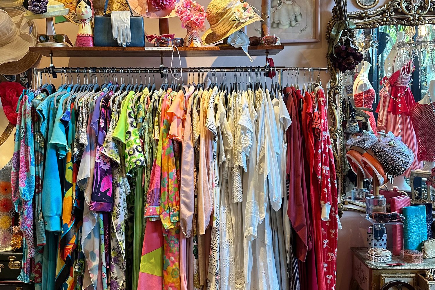 Colorful vintage clothing displayed on hangers in retro style