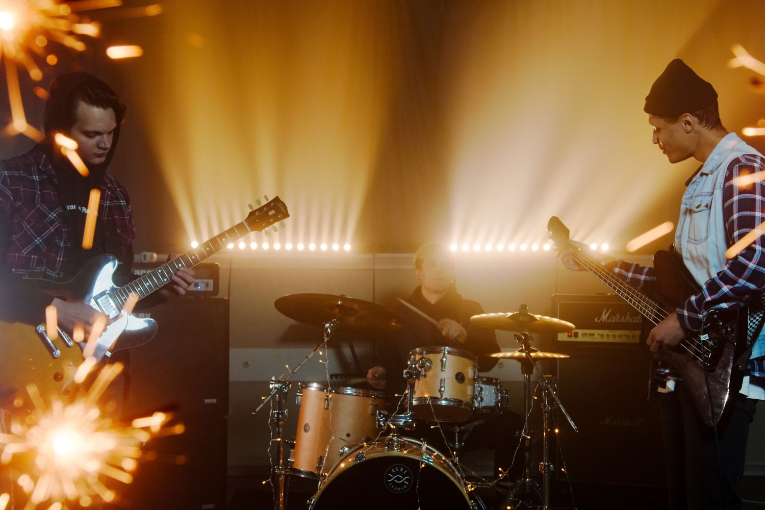 Band performing live on a small club stage under stage lights