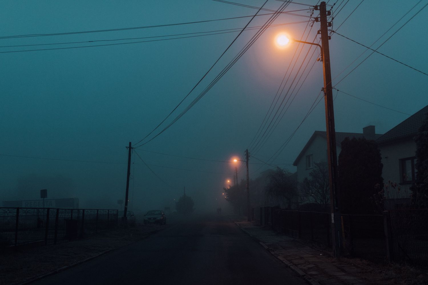 A dimly lit West Mobile street with utility lines at night