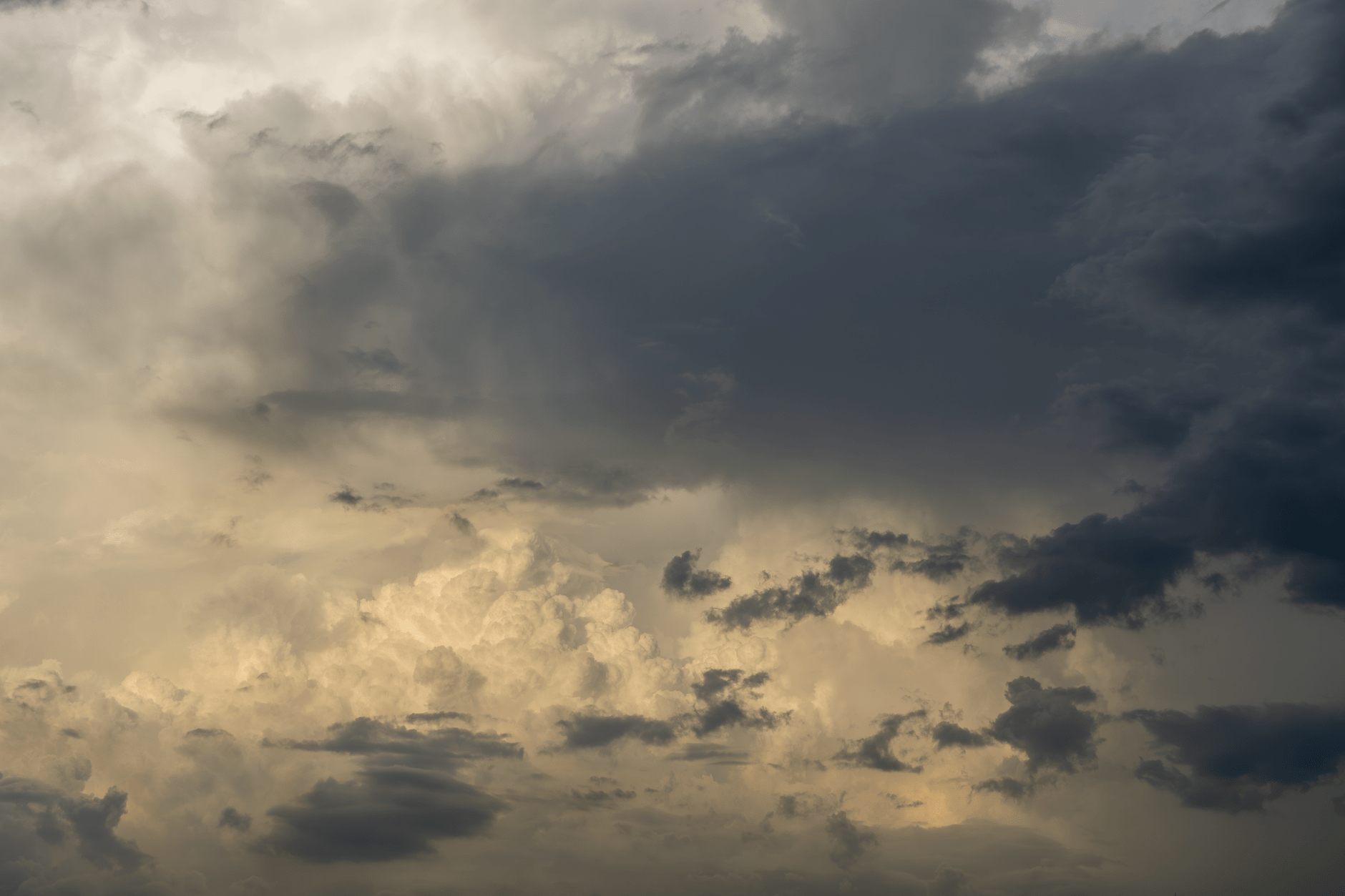 Dramatic storm clouds building in the sky over a coastal landscape