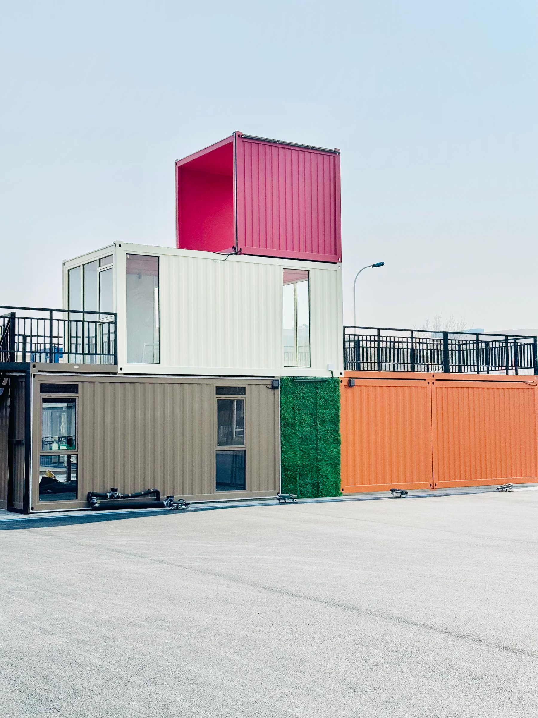 Colorful stacked shipping containers converted into a small multi-level building