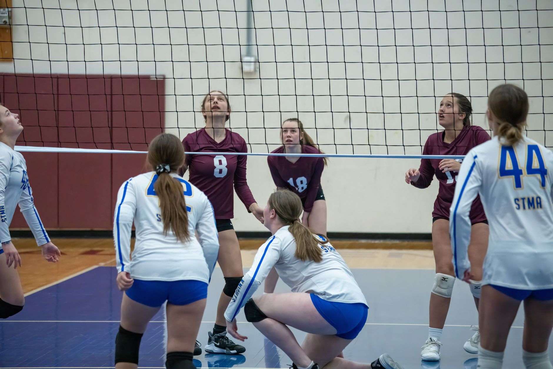 High school volleyball players competing during a match