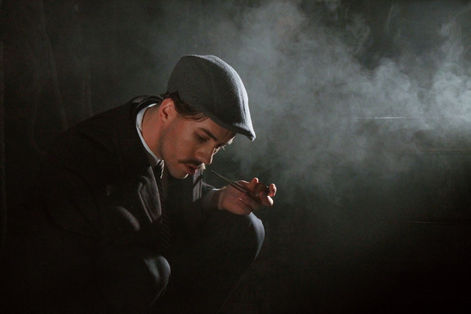 A dramatic vintage scene evoking a 1920s silent film set on the windswept prairie