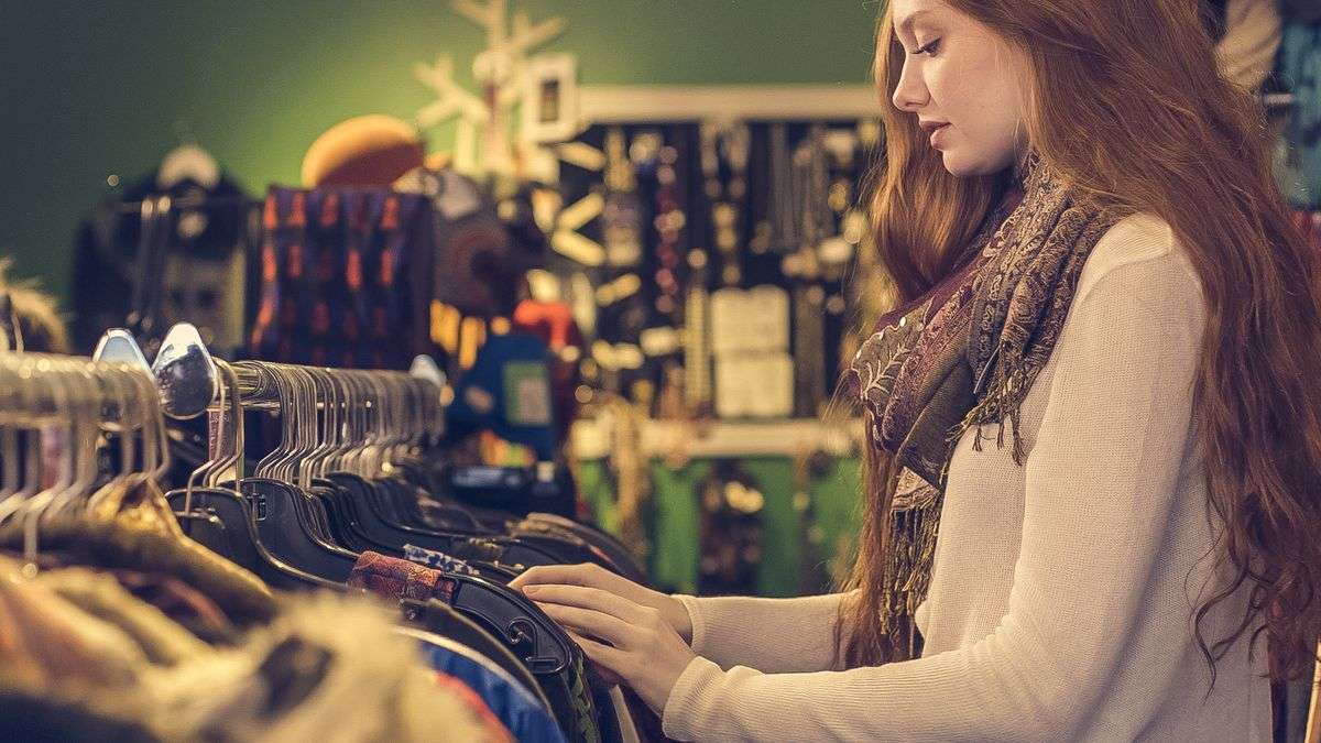 Clothing racks inside a secondhand thrift store, similar to the We Care Thrift Store in downtown Atmore