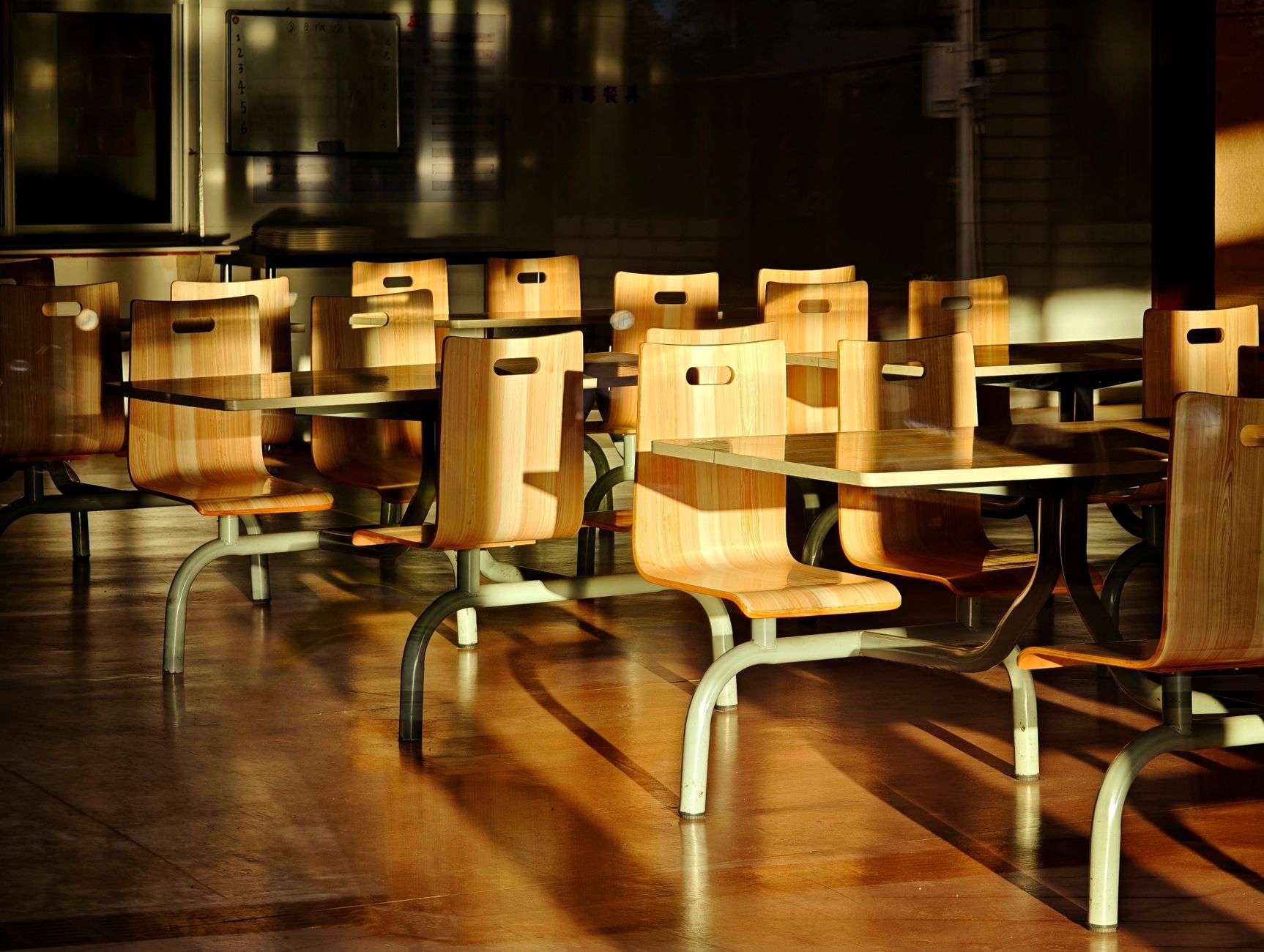 Interior of an empty school cafeteria with tables