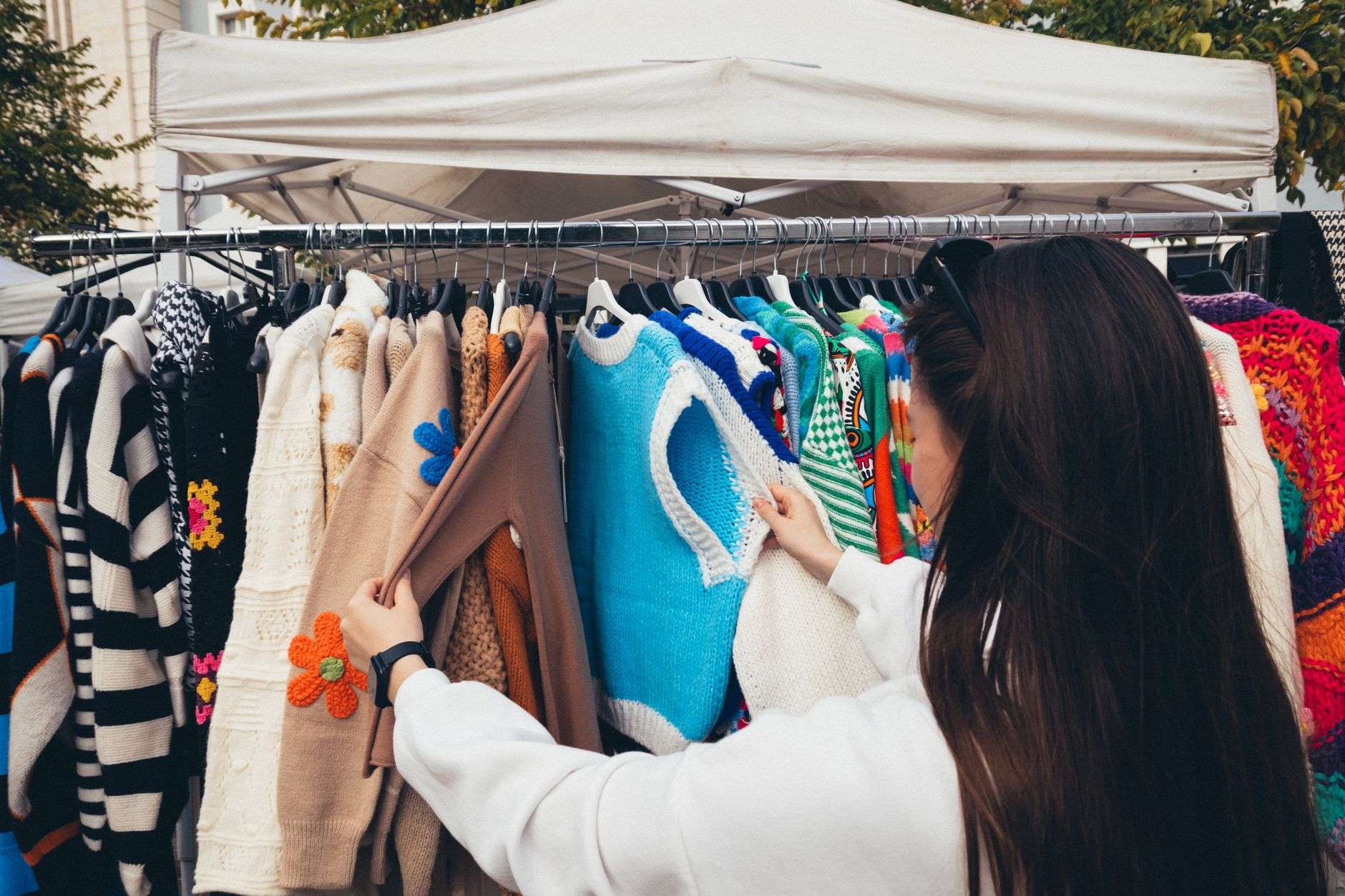 Racks of vintage clothing at an indoor market