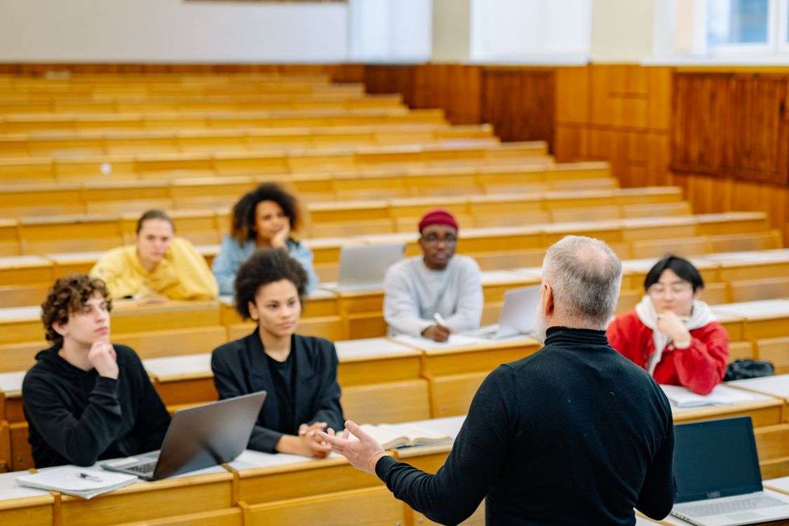 A university lecture hall with rows of seats facing a podium area