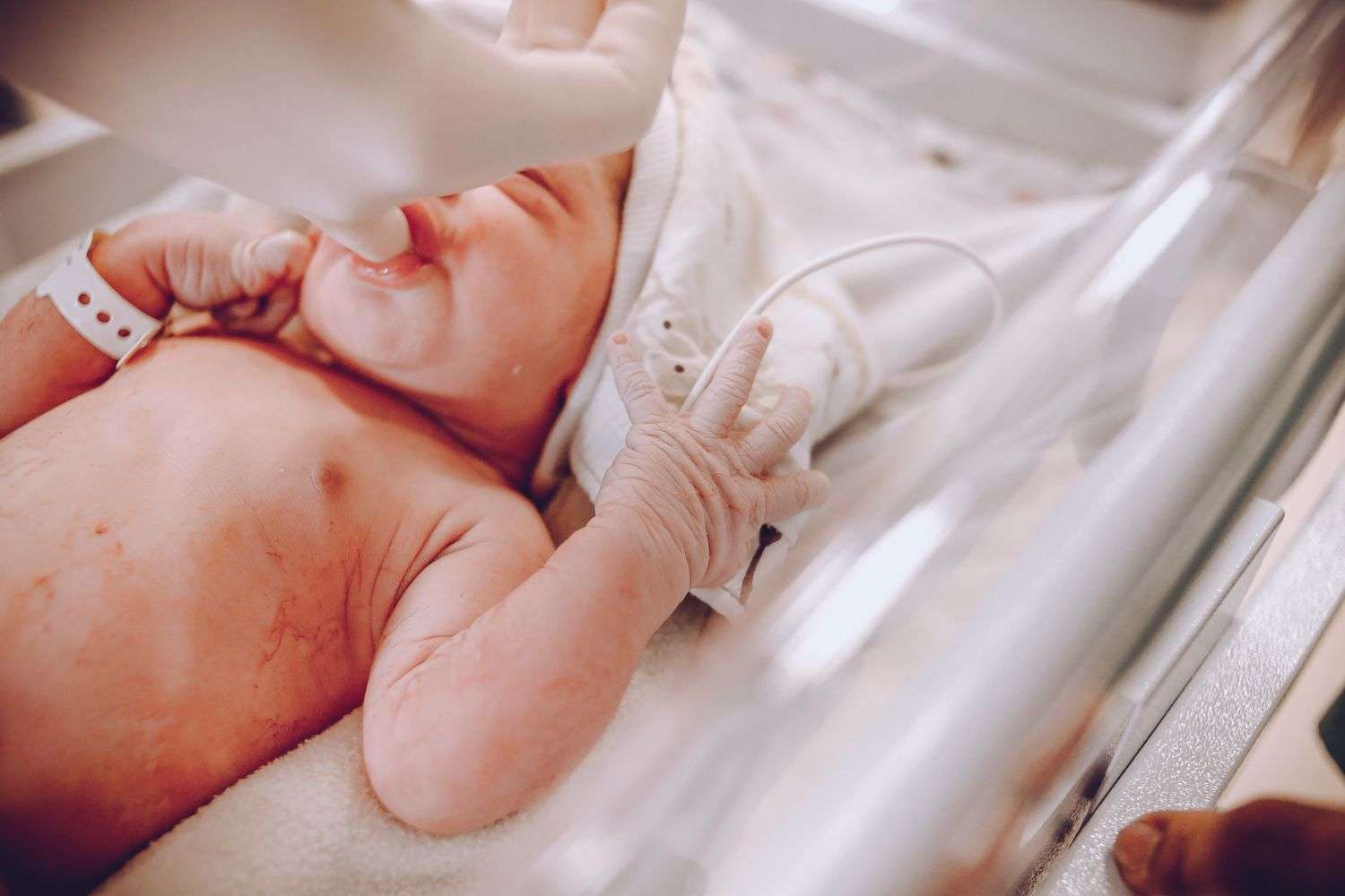 Newborn baby swaddled in a hospital blanket
