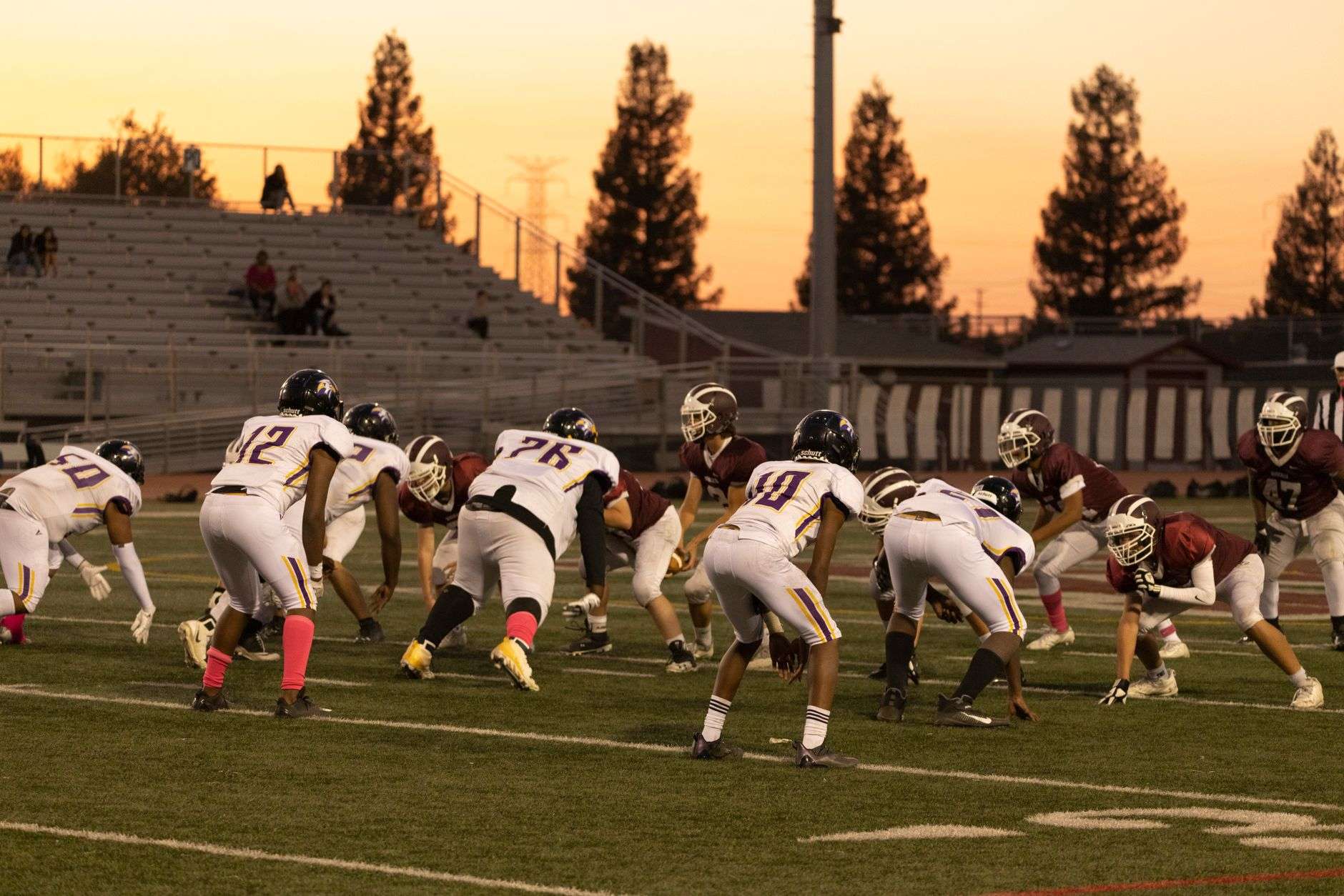 High school football stadium under the lights at night