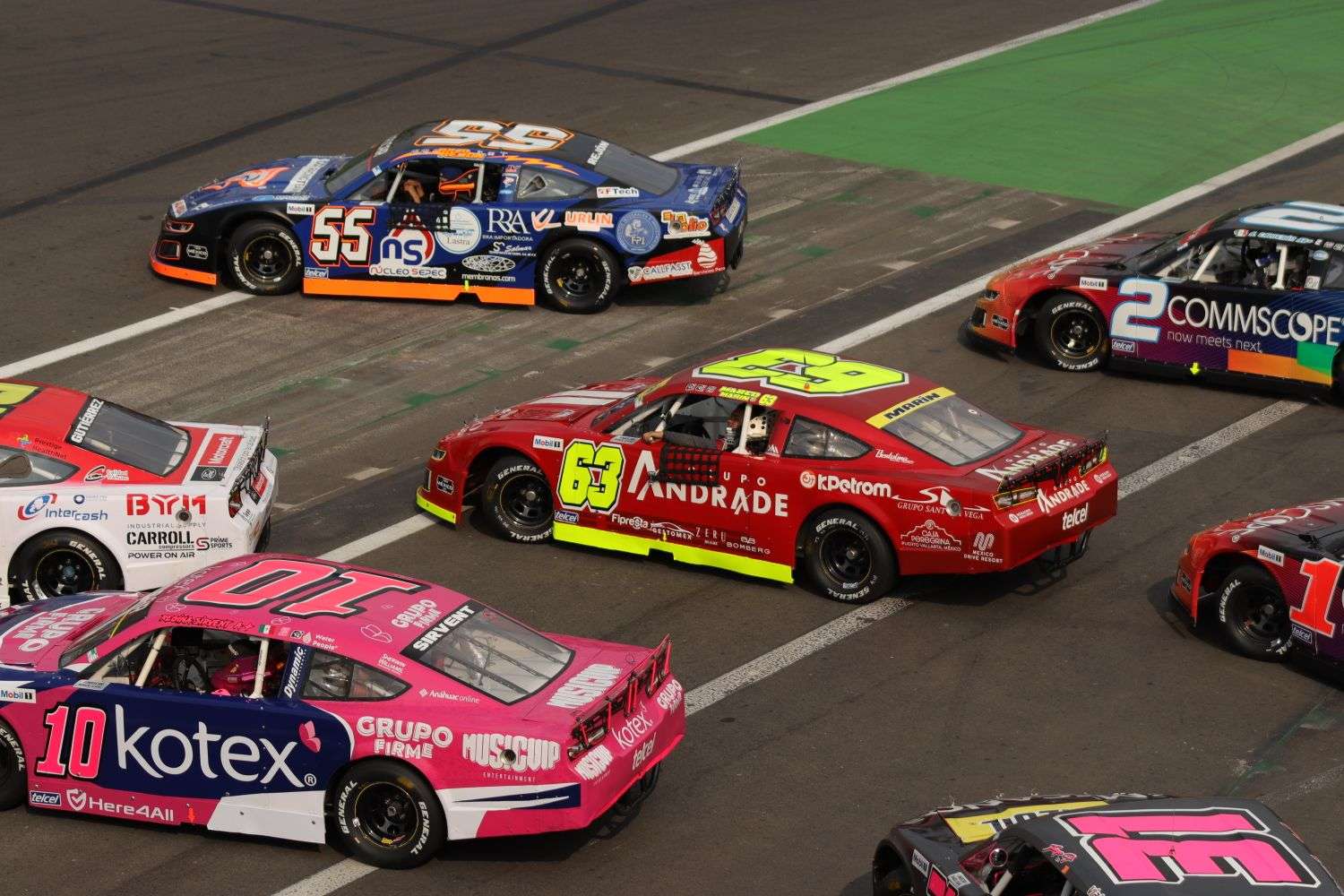 NASCAR stock cars racing in a pack on a superspeedway oval