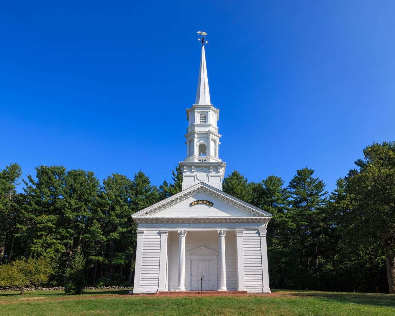 A white church building with a steeple, similar to south Mobile County congregations preparing to rebuild