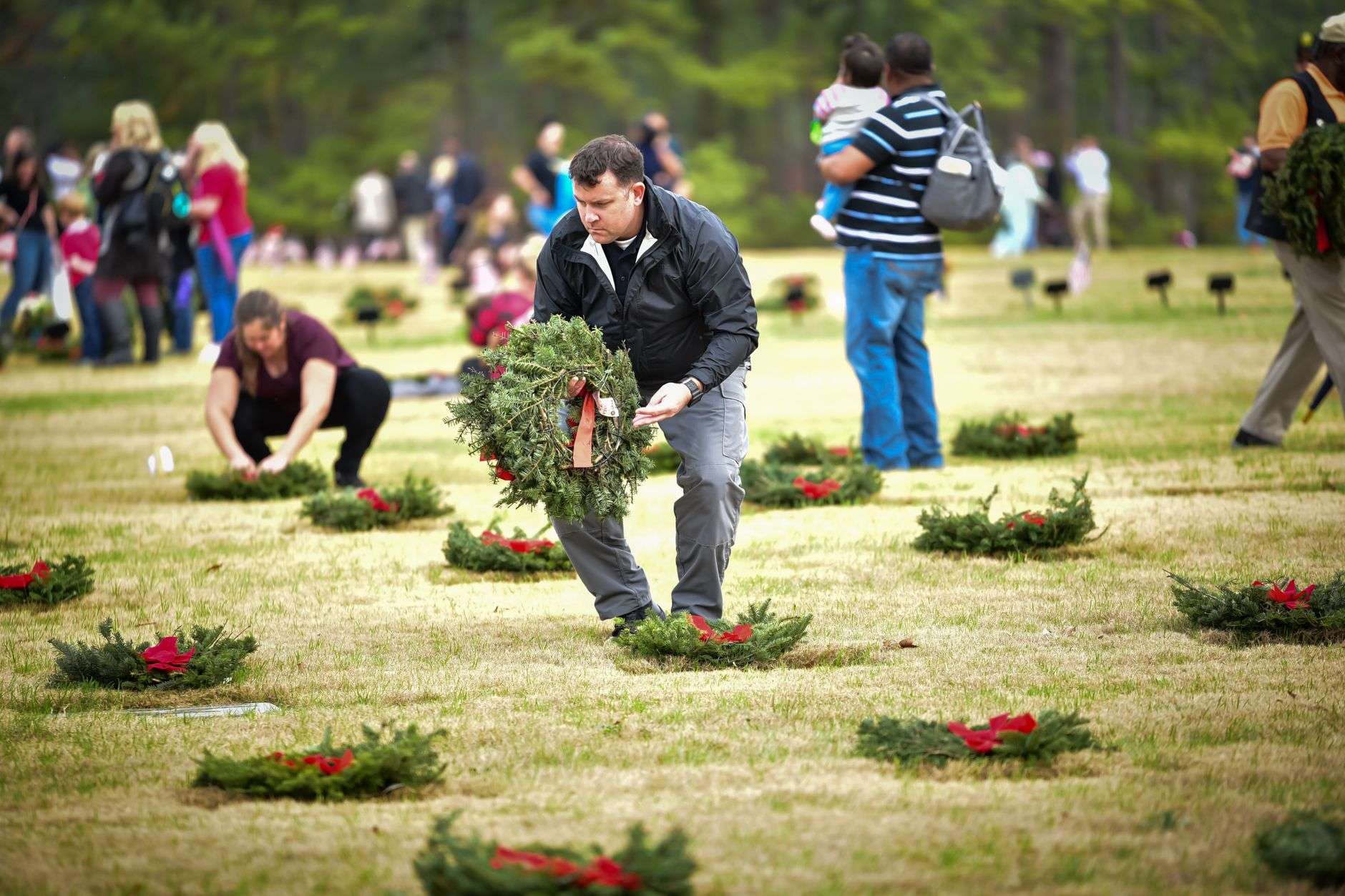 Military wreath displayed during a memorial ceremony at an outdoor pavilion