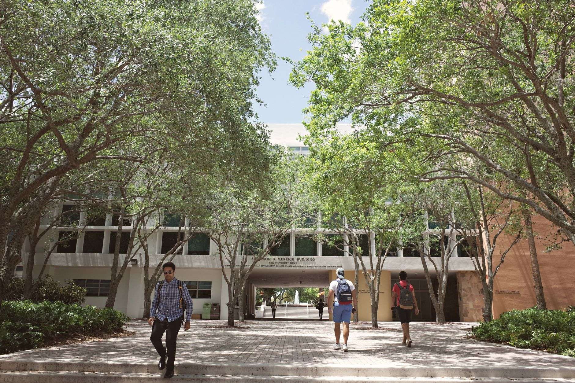 Incoming university students walking across campus during new student orientation