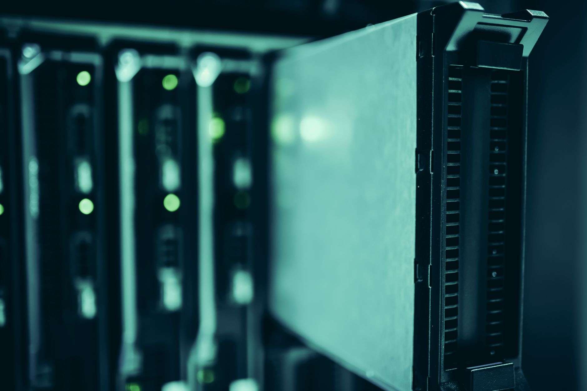 Rows of server racks inside a large data center facility