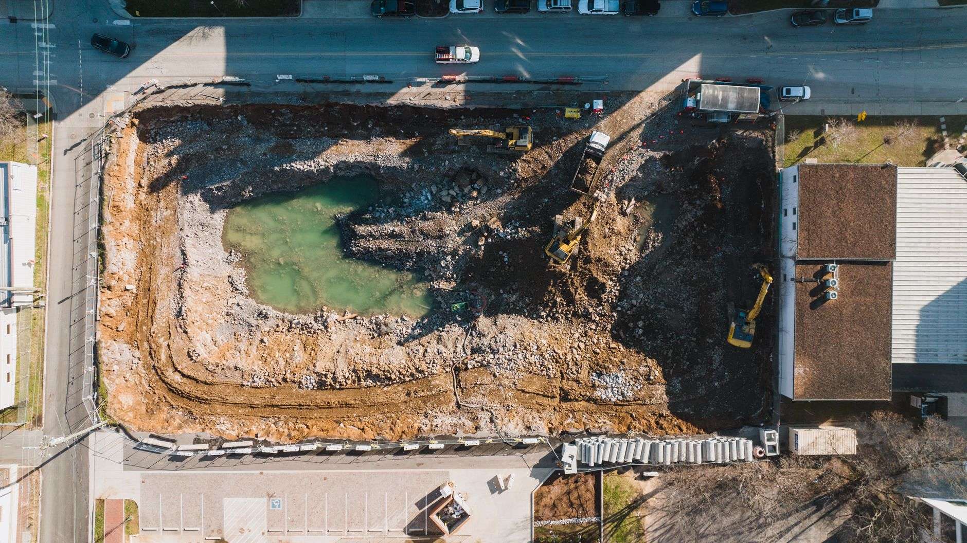 Shovels breaking ground at a hospital construction site for a new emergency department