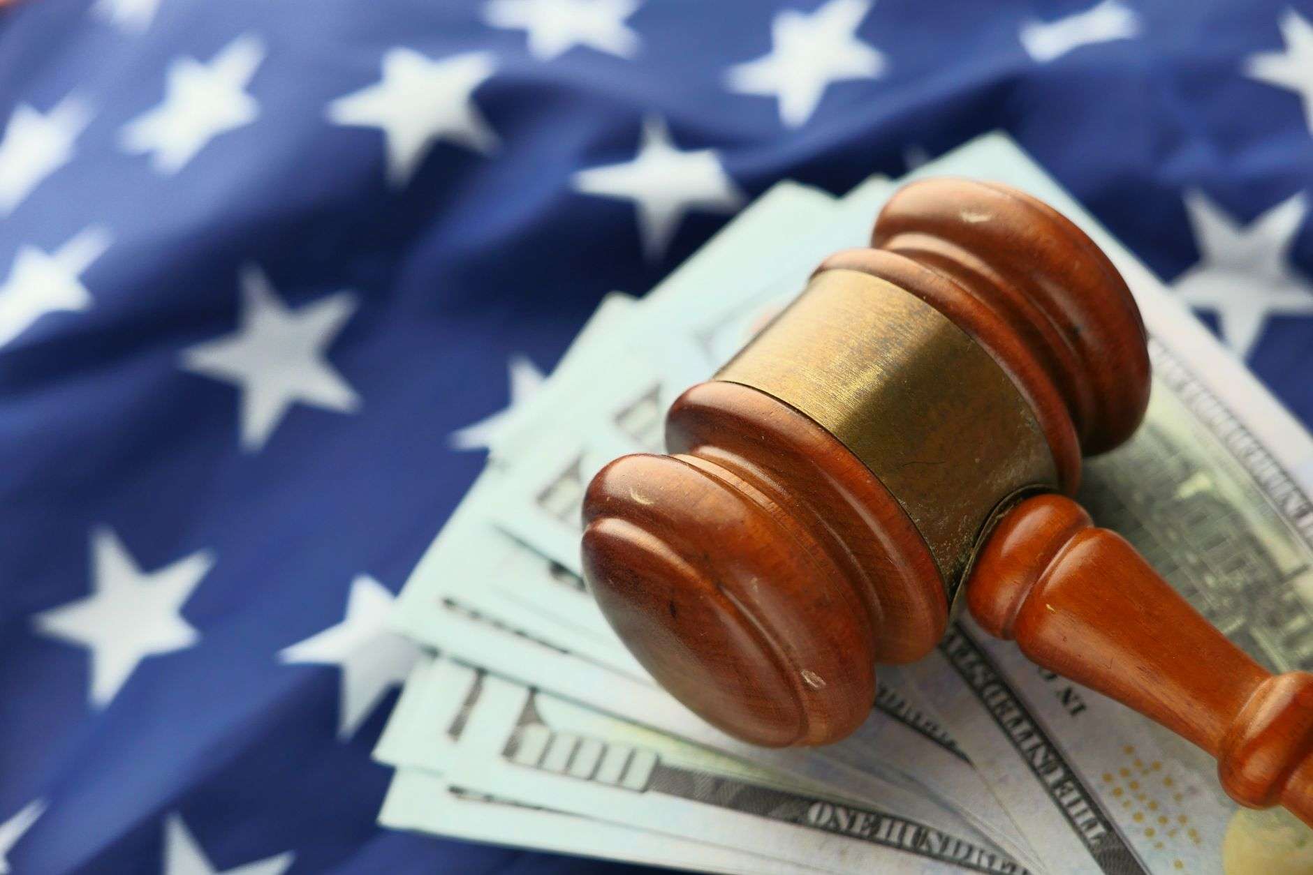 Courtroom gavel resting near financial paperwork and currency, symbolizing a securities fraud prosecution