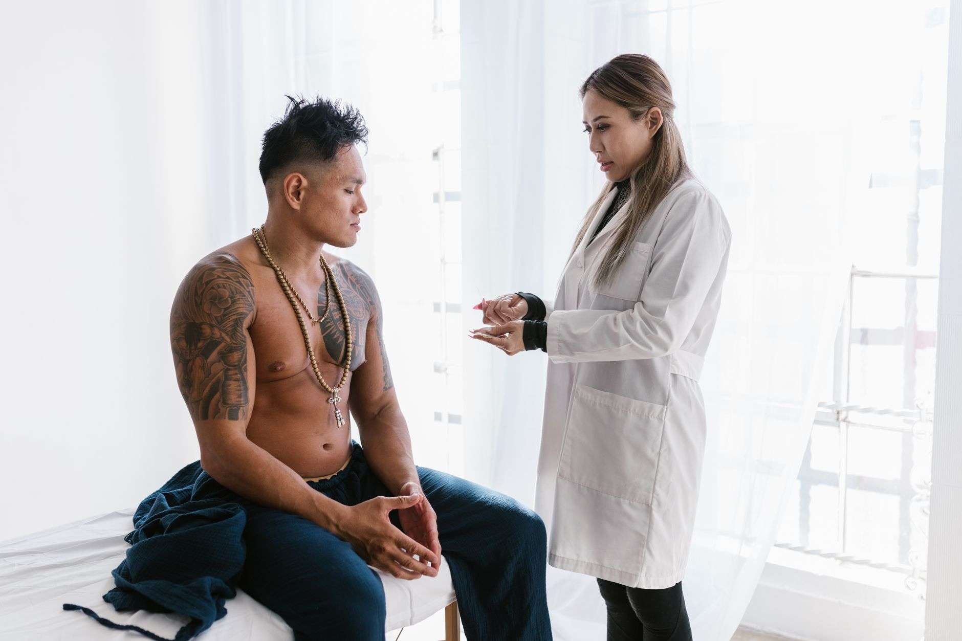 Physician discussing treatment options with a male patient during a clinical consultation