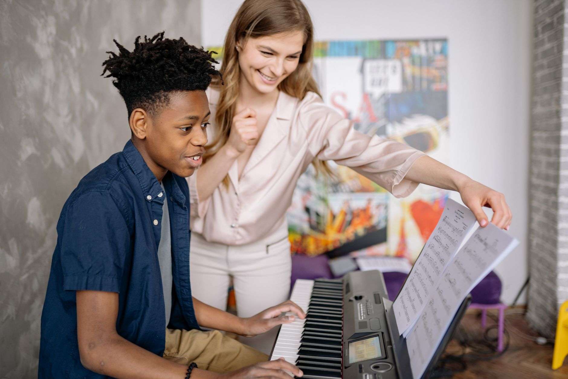 Young student practicing piano as part of a free community music lesson program