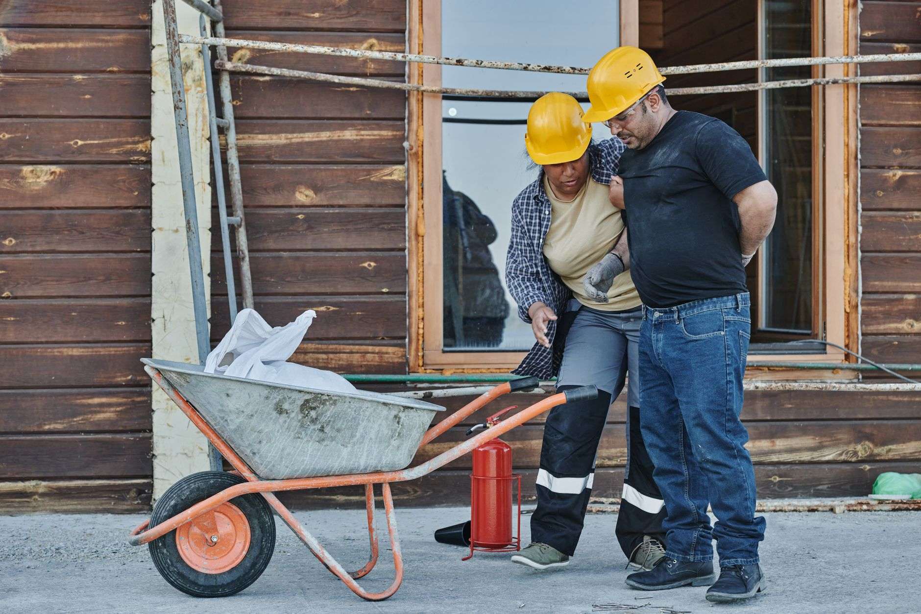 Construction workers taking a water break at an outdoor job site during extreme summer heat