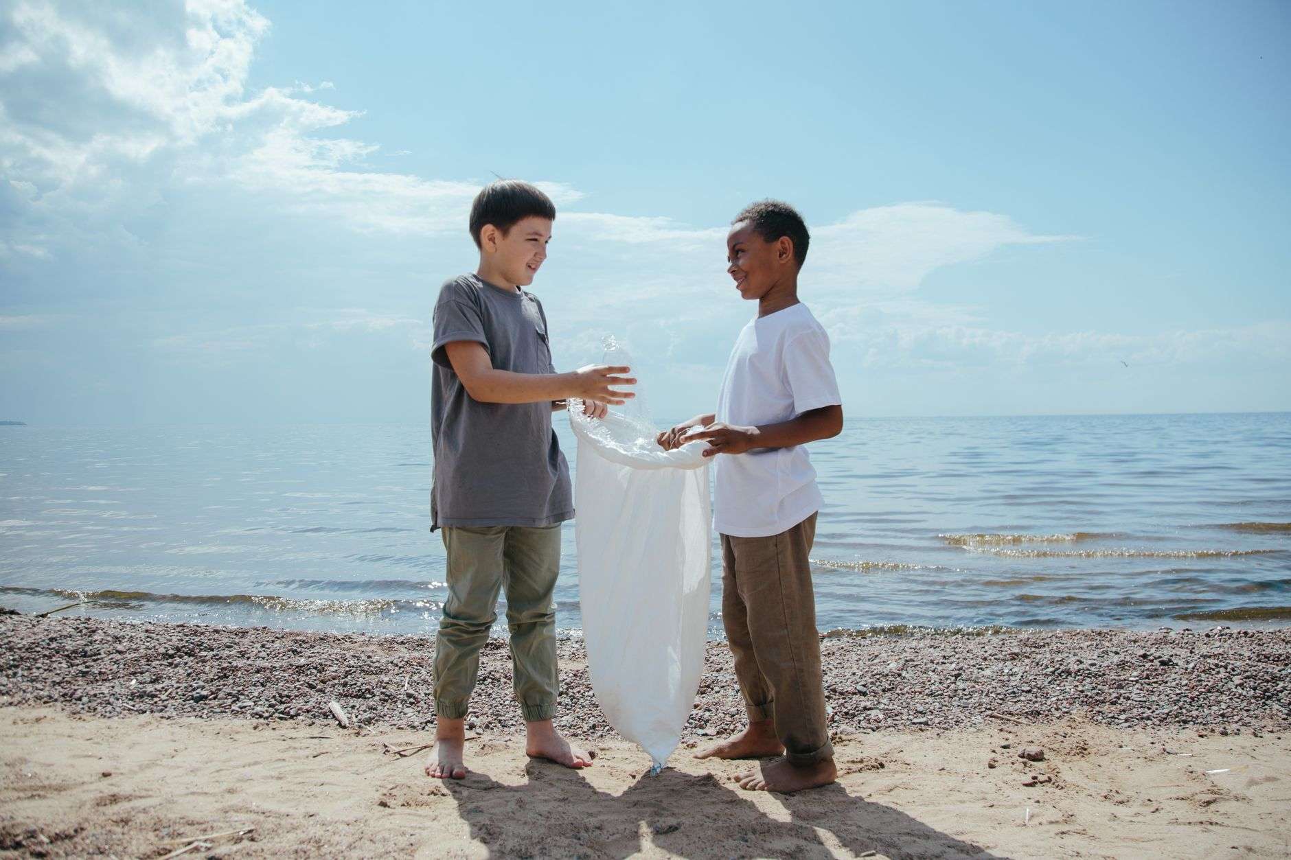 Volunteers collecting litter along a shoreline during a coastal cleanup event