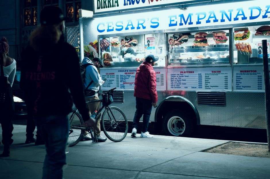 Freshly cooked empanadas at a food truck serving window