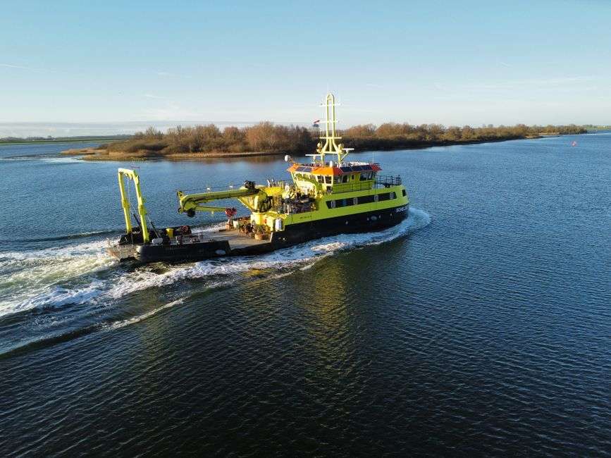 Marine scientists collect samples from a research boat on coastal waters