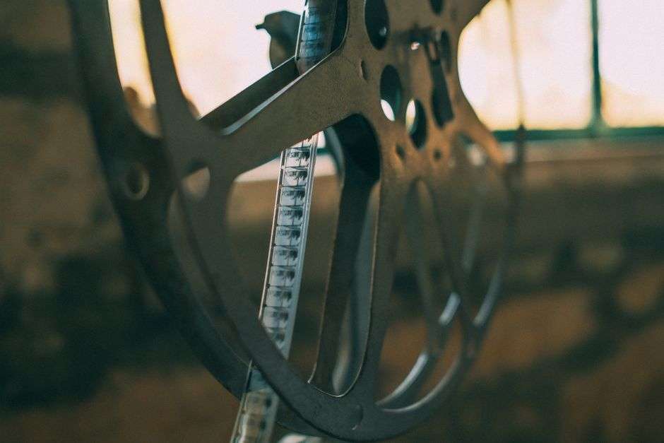 Film projector and reels glowing in a darkened theater