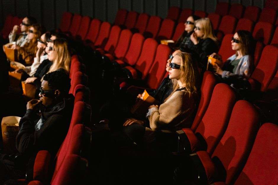 Movie audience watching a film in a darkened theater