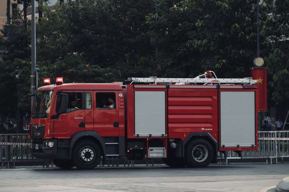 Red fire engine with emergency lights on a neighborhood street