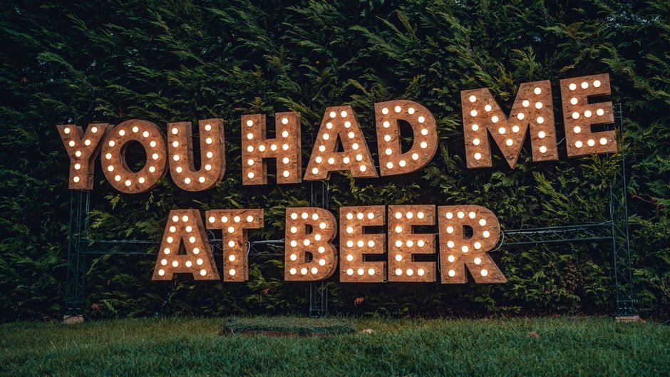 Large illuminated marquee letters spelling a message at a party