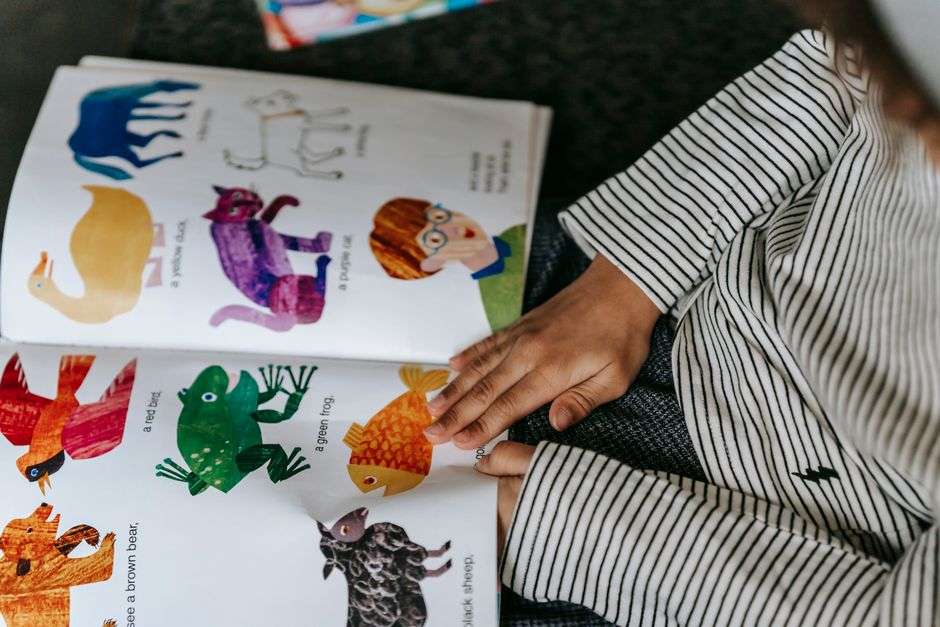 A child reading a colorful illustrated children's picture book