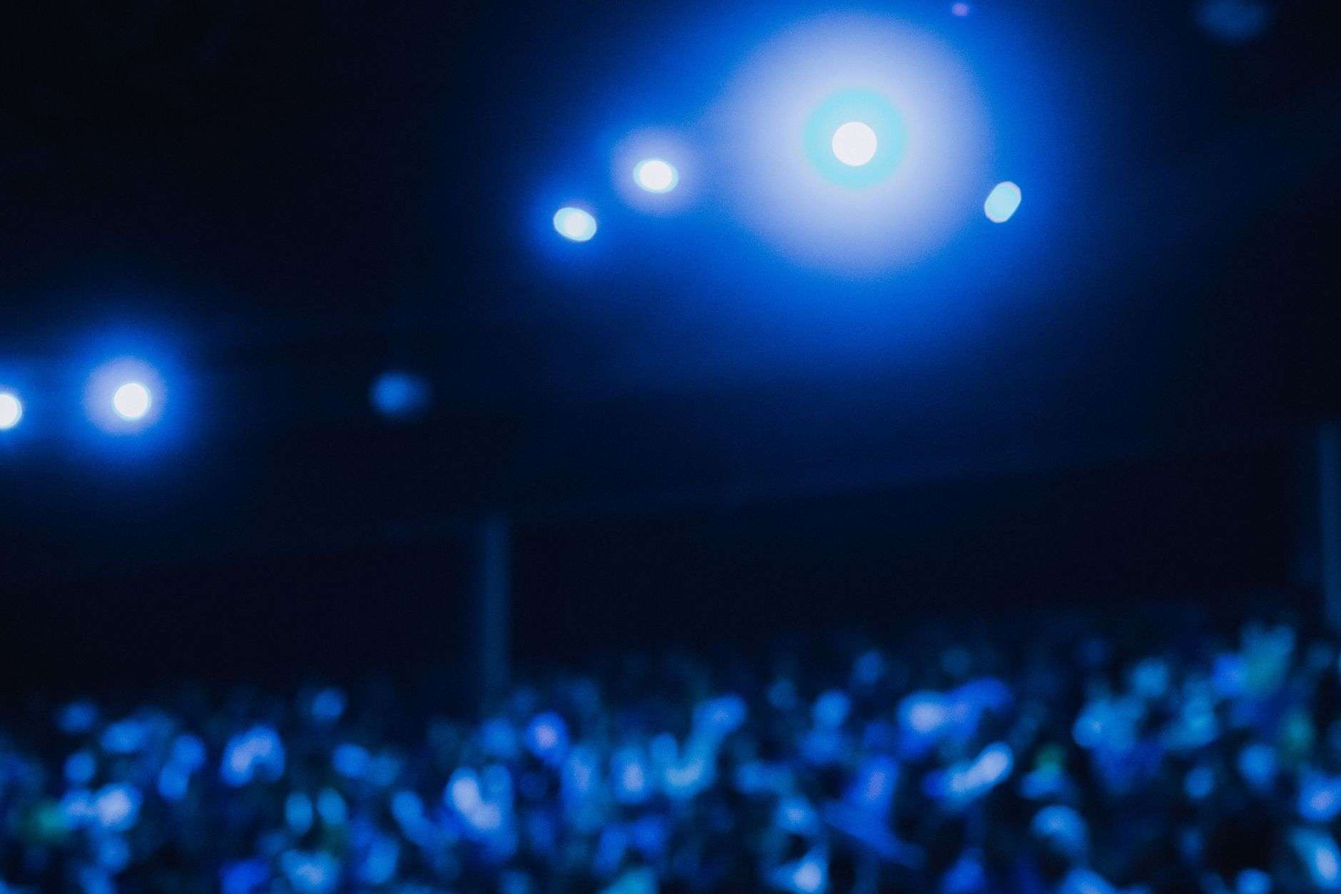 An audience watches a stage performance inside an ornate historic theater
