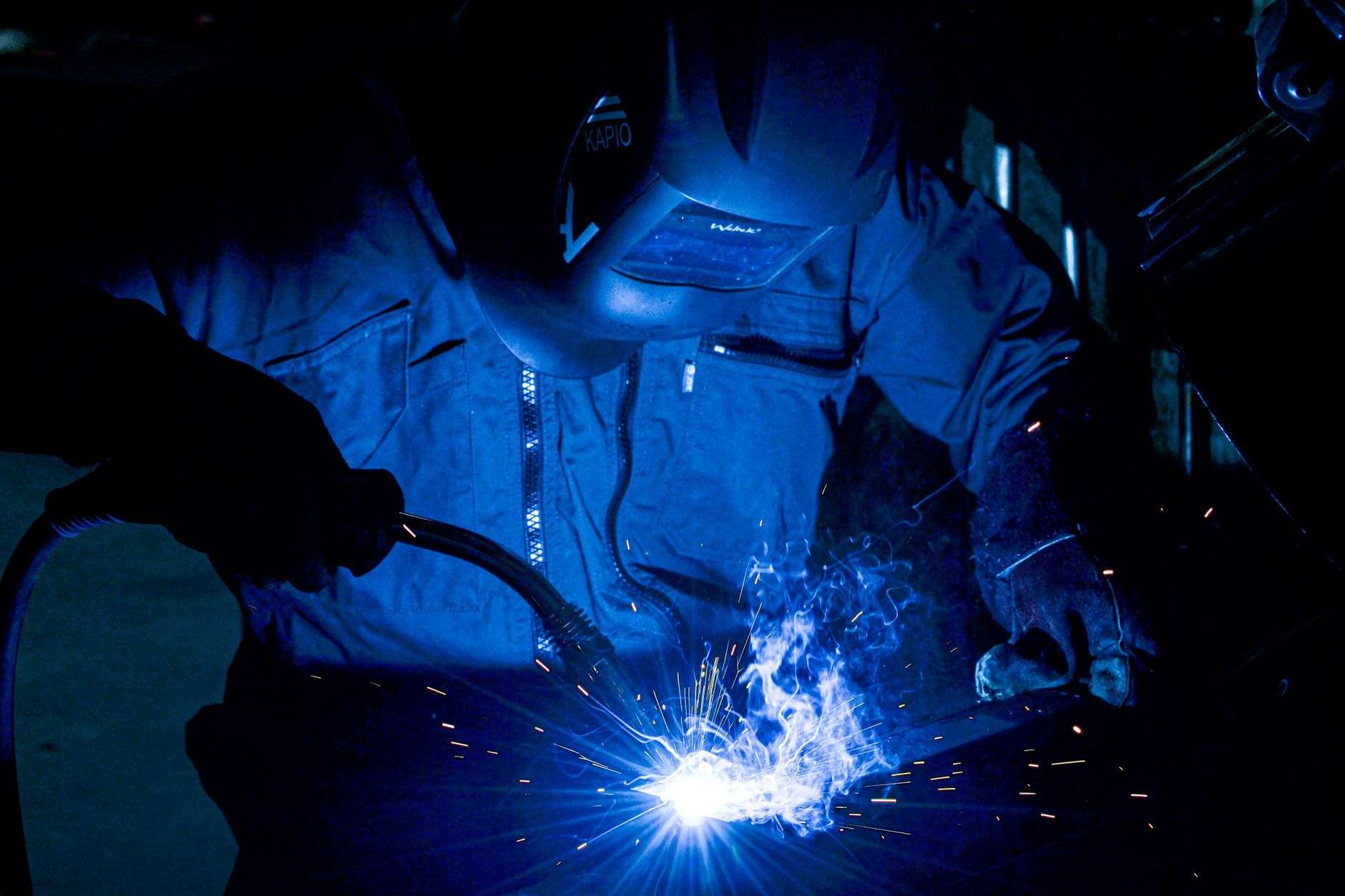 A student practicing welding in a training workshop