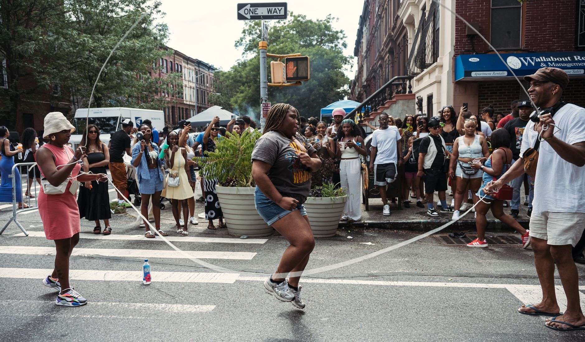 Neighbors gathered outdoors at a community block party on a sunny afternoon