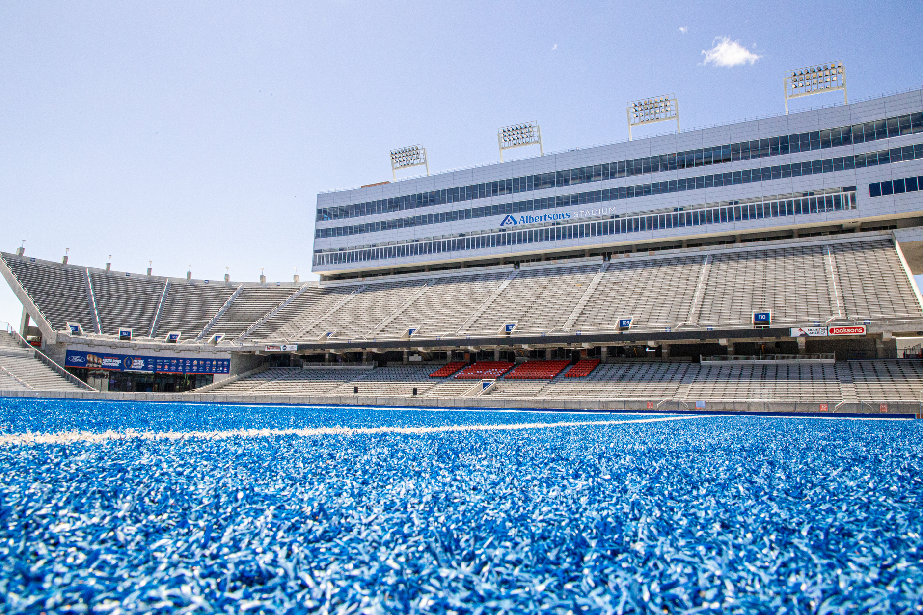 A college football game underway in a large stadium filled with fans