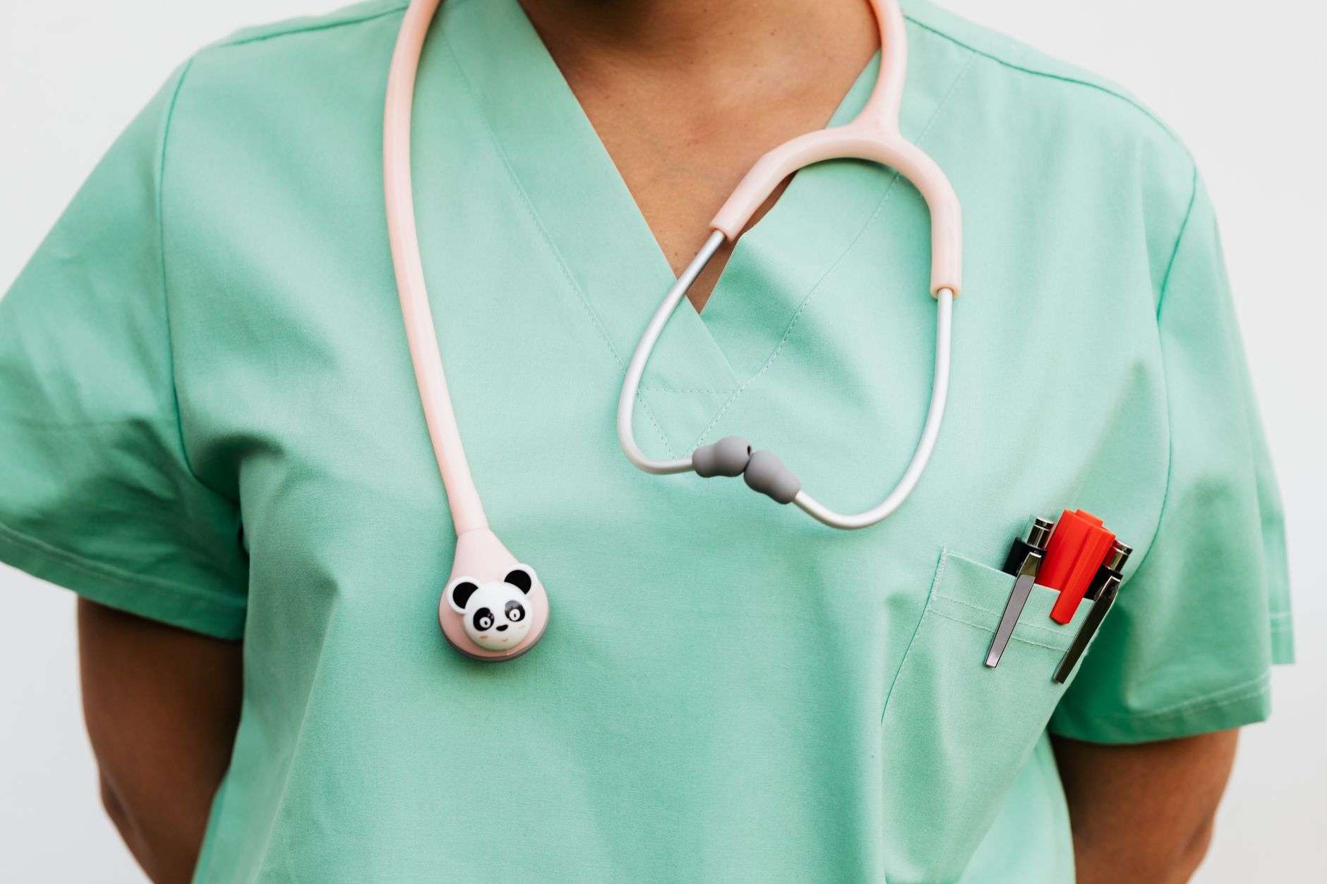 A nurse in scrubs working in a clinical setting, illustrating Alabama advanced practice nursing licensure