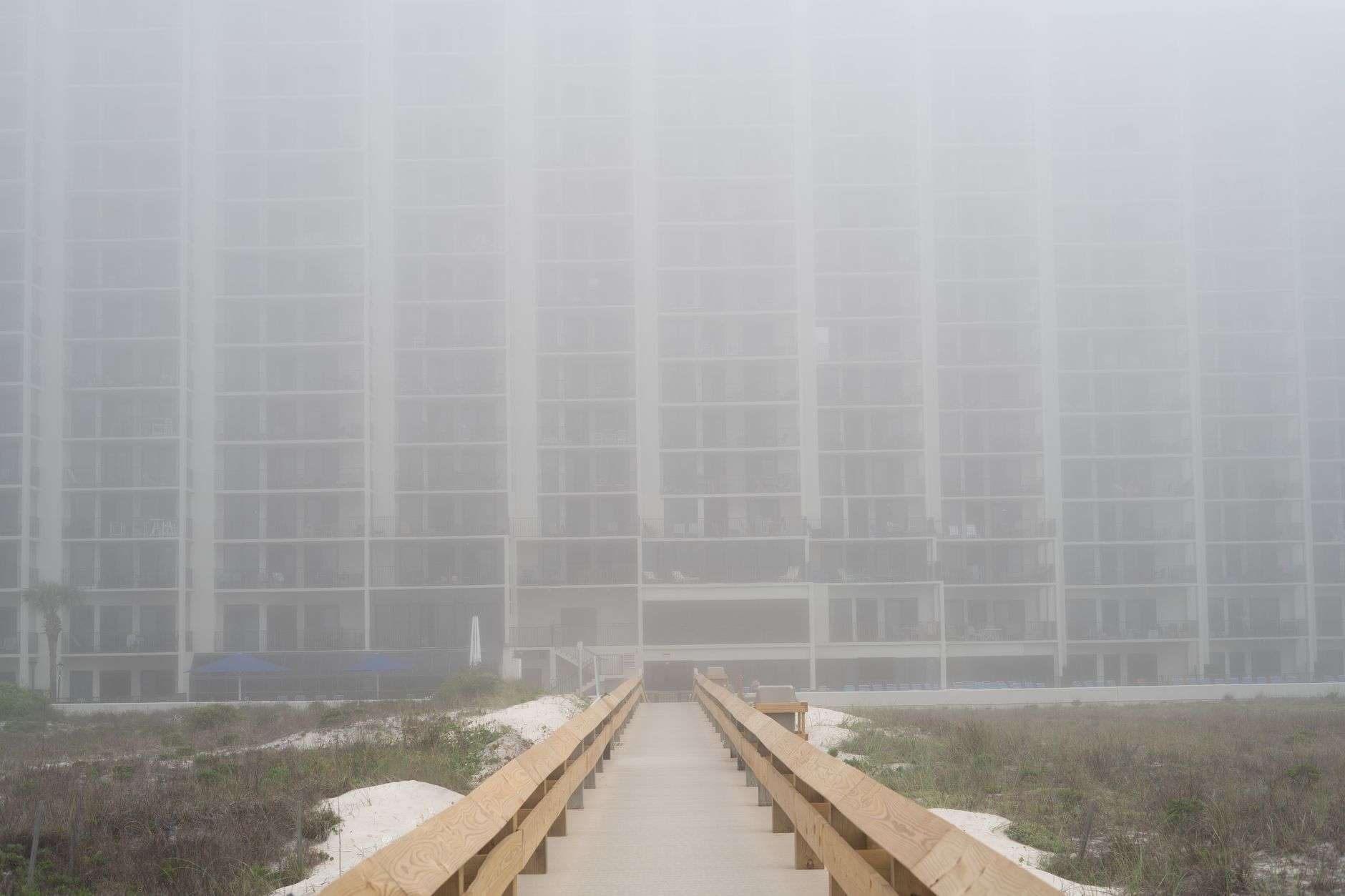 High-rise condominiums and hotels lining a white sand Gulf Coast beach