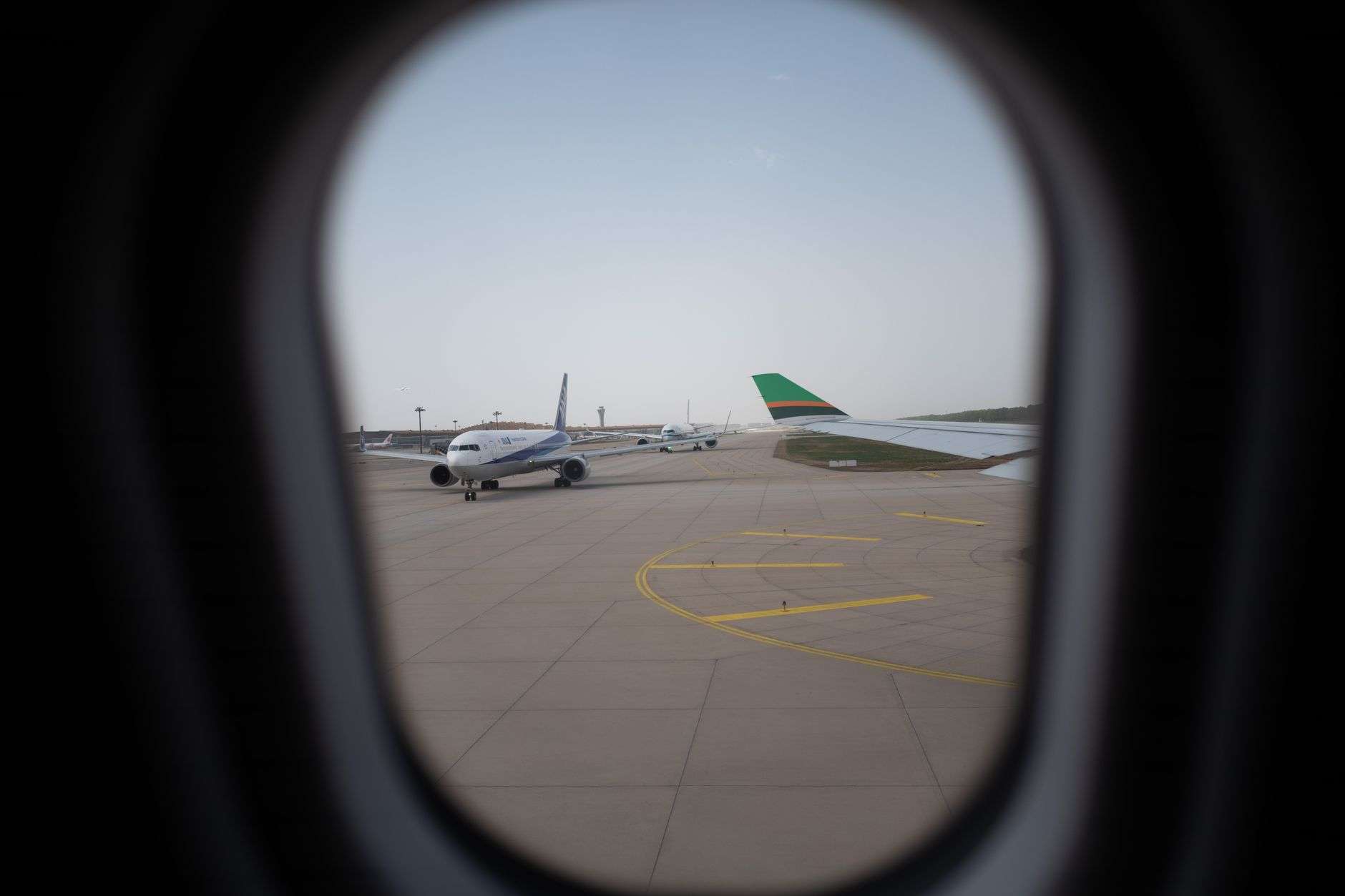 A commercial passenger jet on the tarmac at an airport