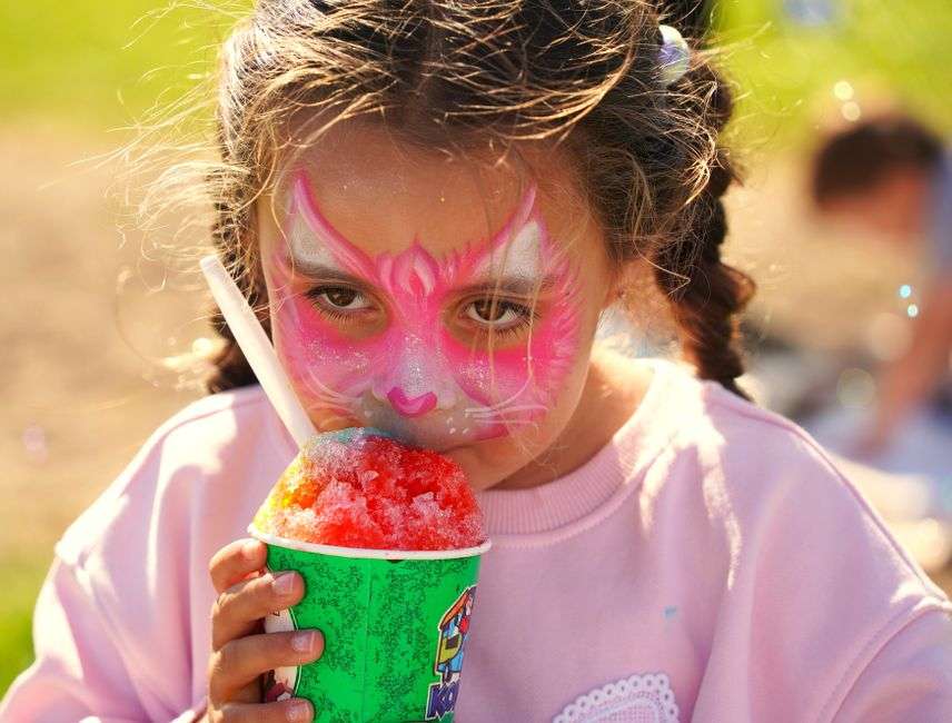 A colorful shaved ice sno ball in a cup